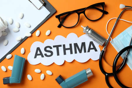 Concept of Asthma treatment on orange background, top viewの写真素材