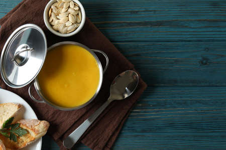 Concept of tasty food with pumpkin soup on wooden tableの写真素材