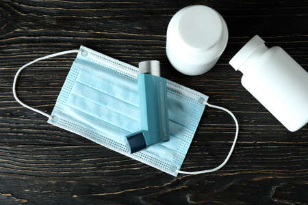 Asthma treatment accessories on rustic wooden table