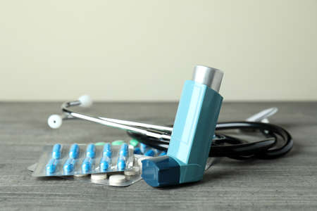 Asthma treatment accessories on gray textured table
