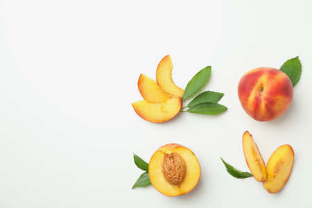 Ripe peach fruits with leaves on white backgroundの写真素材