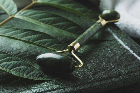Skin care concept with green face rollerの写真素材