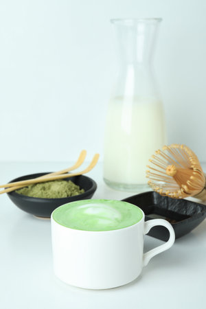 Matcha latte and accessories for making on white tableの写真素材