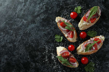 Delicious bruschetta snacks on black smokey backgroundの写真素材