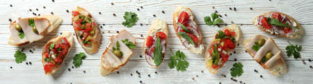 Delicious italian snacks bruschetta on white wooden backgroundの写真素材