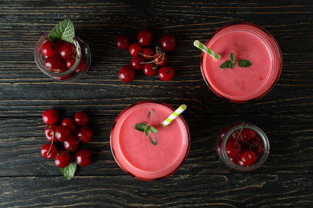 Cherry smoothie and ingredients on rustic wooden tableの写真素材