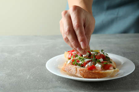 Concept of cooking bruschetta snacks on gray textured tableの写真素材
