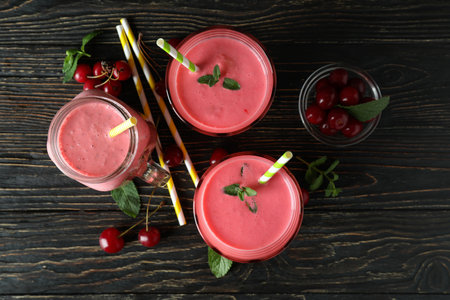 Cherry smoothie and ingredients on rustic wooden tableの写真素材