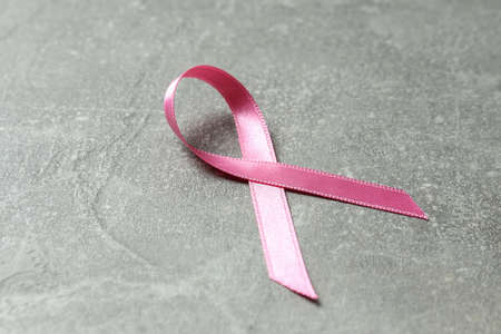 Breast cancer awareness ribbon on gray textured backgroundの写真素材