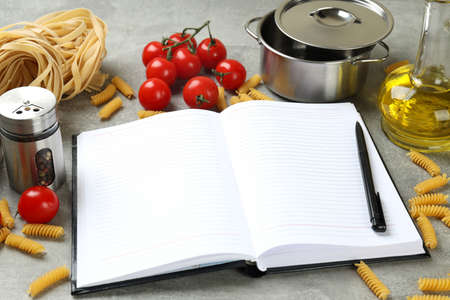 Concept of recipe on gray textured table, space for textの写真素材