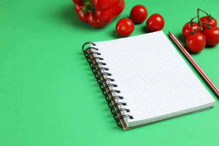 Concept of blank recipe book on green background