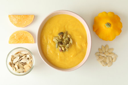Flat lay with pumpkin soup ingredients on white backgroundの写真素材