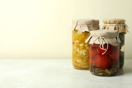 Jars of pickled vegetables on white textured backgroundの写真素材
