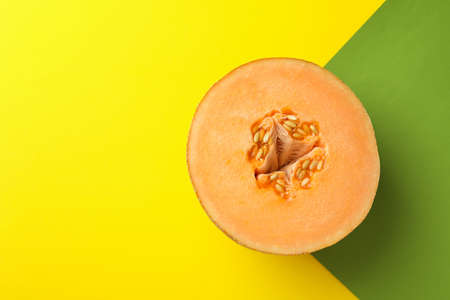 Melon half on two tone background, space for textの写真素材