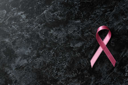 Breast cancer awareness ribbon on black smokey backgroundの写真素材
