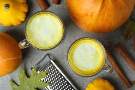 Concept of pumpkin latte on gray textured tableの写真素材