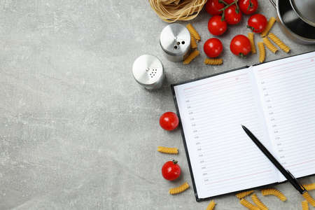 Concept of recipe on gray textured table, space for text