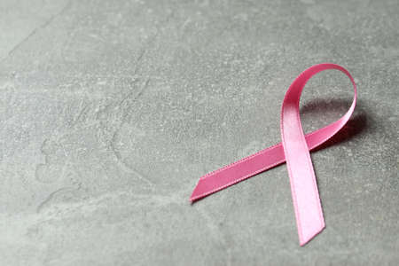 Breast cancer awareness ribbon on gray textured backgroundの写真素材
