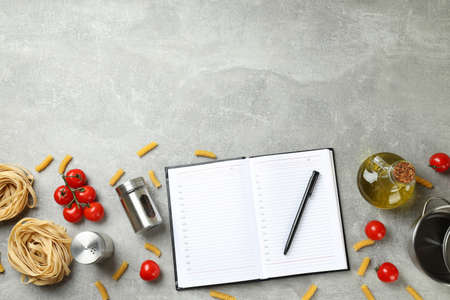 Concept of recipe on gray textured table, space for textの写真素材
