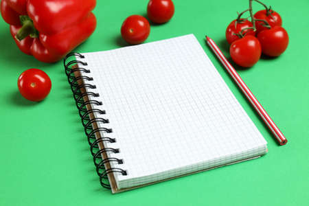 Concept of blank recipe book on green background