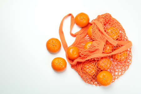 String bag with mandarins on white backgroundの写真素材
