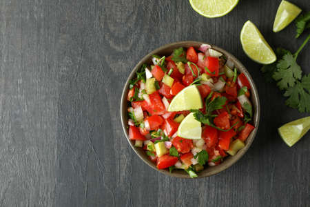 Mexican food concept with Pico de Gallo on dark wooden table