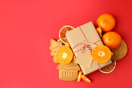 Christmas concept with mandarins on red backgroundの写真素材