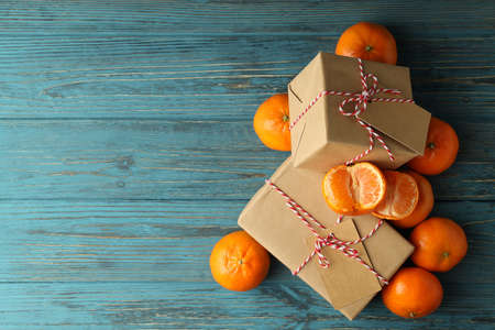 Mandarins and gift boxes on wooden tableの写真素材