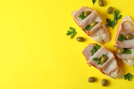 Delicious italian snacks bruschetta on yellow backgroundの写真素材