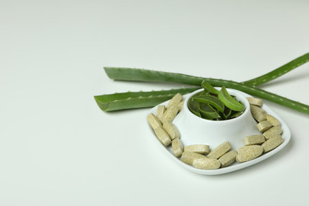 Concept of natural herb pills with aloe on white backgroundの写真素材