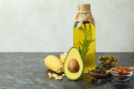 Bottle of oil and ingredients on black smokey table