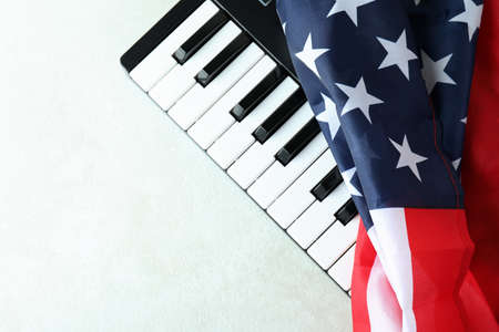 Midi keyboard and american flag on white textured backgroundの写真素材
