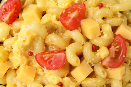 Macaroni with cheese all over background, close upの写真素材
