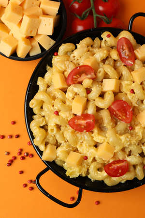 Concept of tasty eating with macaroni with cheese on orange backgroundの写真素材