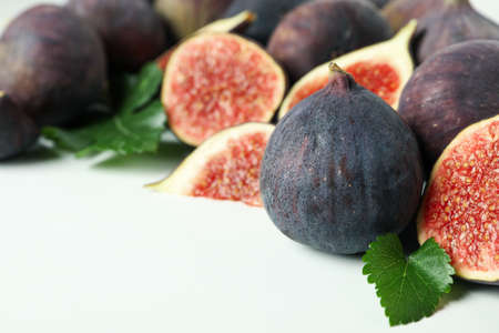 Fig with leaves on white background, space for text