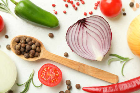 Different spicy vegetables on white textured backgroundの写真素材