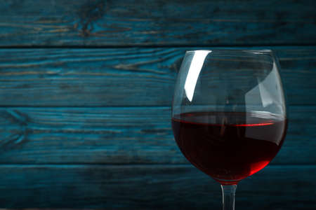 Glass of red wine on rustic wooden backgroundの写真素材