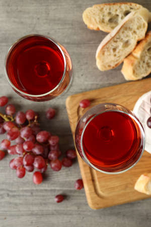 Concept of tasty eating with red wine on gray textured table