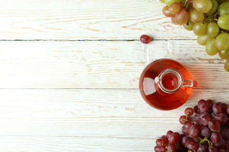Vinegar and grape on white wooden tableの写真素材