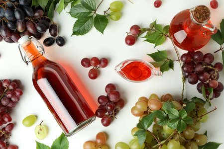 Bottles of vinegar and grape on white background, top viewの写真素材