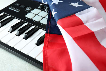 Midi keyboard and american flag on white textured backgroundの写真素材