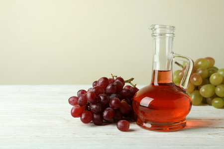 Vinegar and grape on white wooden tableの写真素材