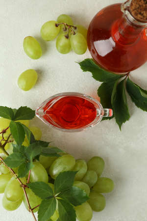 Concept of grape vinegar on white textured tableの写真素材