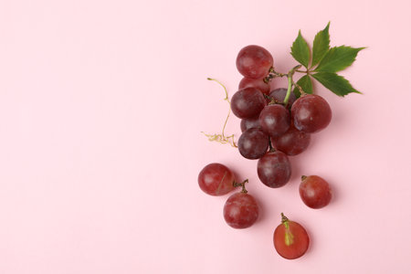 Red ripe grape on pink background, space for textの写真素材