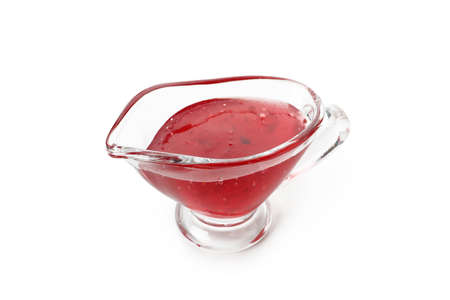Sauce boat with cranberry sauce isolated on white backgroundの写真素材