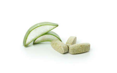 Concept of herb pills with aloe isolated on white backgroundの写真素材