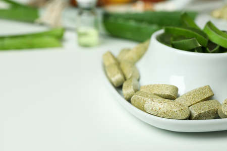 Concept of herb pills and cosmetics with aloe on white backgroundの写真素材