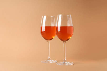 Two glasses of wine on beige backgroundの写真素材
