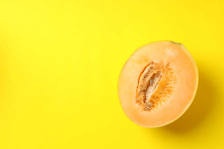 Half of juicy melon on yellow backgroundの写真素材