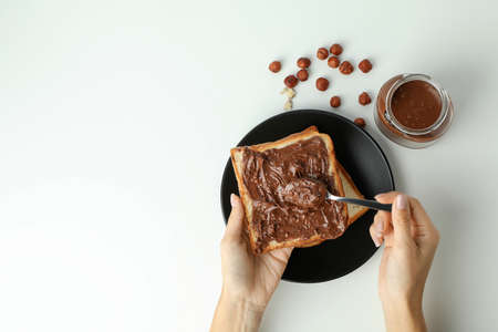 Concept of tasty breakfast with chocolate paste on white backgroundの写真素材